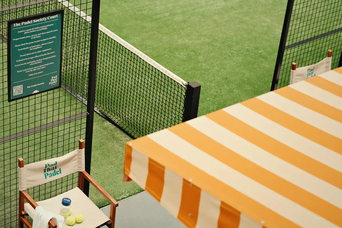 Courtside lounge with striped awning